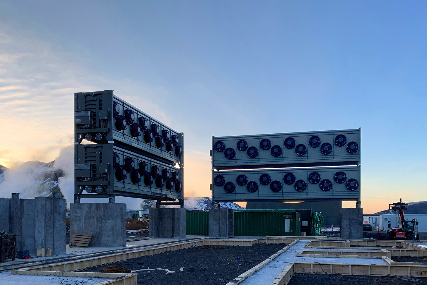 Four carbon collector units pictures against a blue sky, installed at Climeworks’ Orca plant.